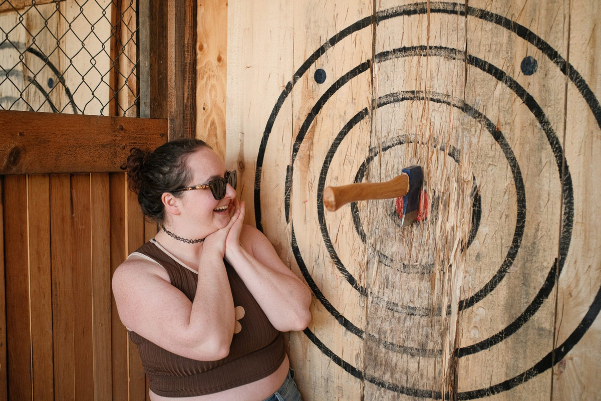 An axe stuck in the centre of a wooden target