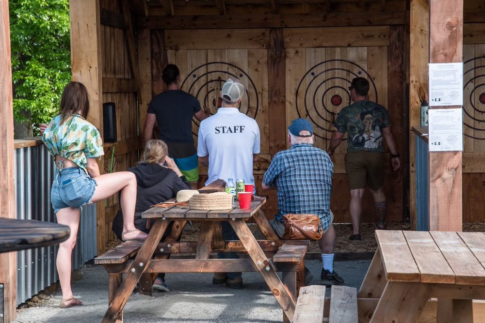 Guests gathered at the axe throwing lanes