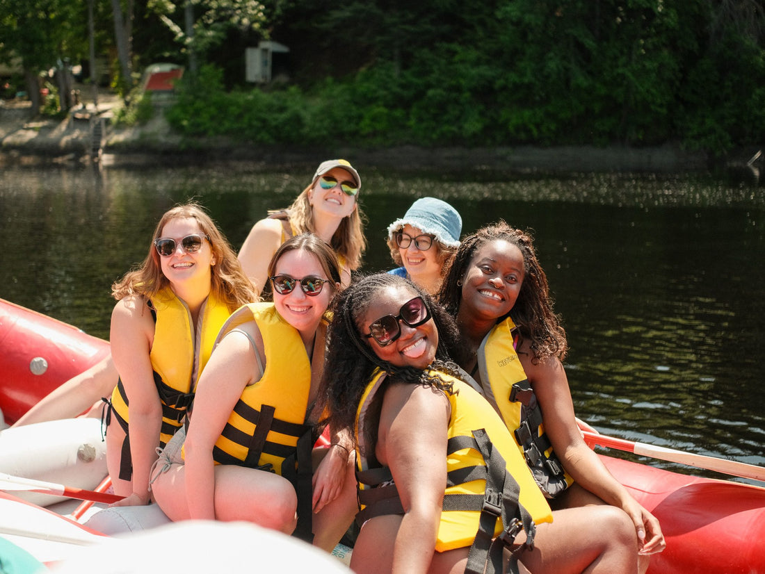 Guests wearing fitted life jackets on the river