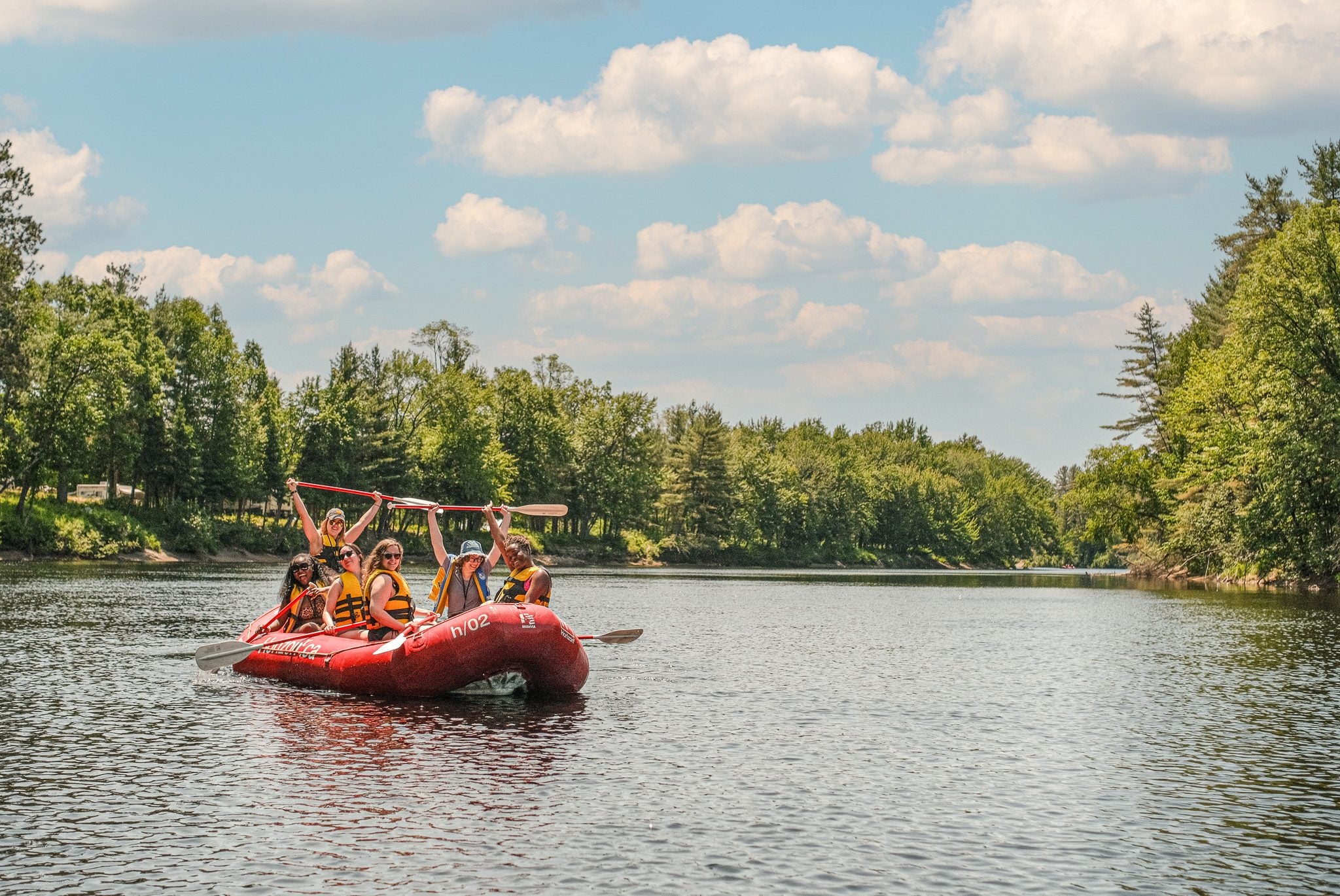 Guests celebrating on a raft on the river